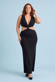 Robe longue noire à encolure asymétrique, découpes à la taille et détails dorés | Porté sur une silhouette plus ronde | Lounelle Paris